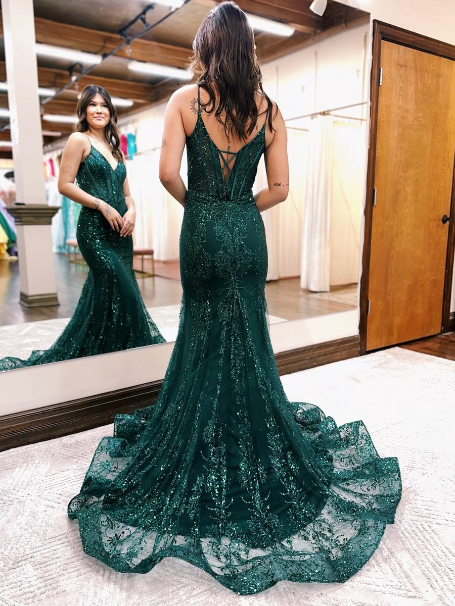 Prom dress features exposing boning in the bodice and back and an all over glitter pattern with a stunning train